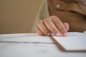 women hand reading a food menu at cafe. photo