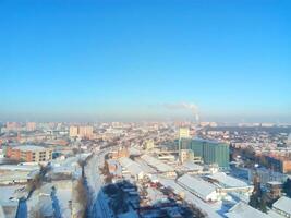 Winter town. Frosty sunny day in the city. Snow on the streets and smoke from the boiler rises. Frost and sun, a wonderful day photo