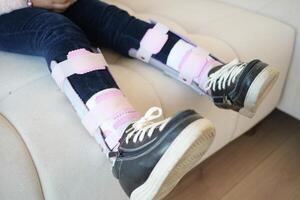 Child cerebral palsy disability, legs orthosis. photo