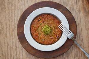 Turkish dessert kunefe, kunafa, kadayif with pistachio photo