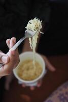 Eating Instant Noodles with a Fork. photo