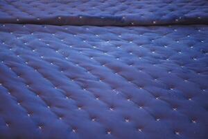 Background of blue comfortable mattress, top view photo
