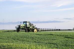 Tractor with a spray device for finely dispersed fertilizer. photo