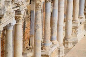 Columns on the stage of the amphitheater. Ancient antique amphitheater in city of Hierapolis in Turkey. photo