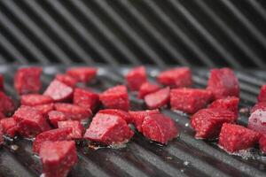 slice of salami sausage on the grill photo