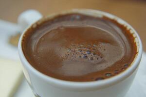 a cup of turkish coffee on table photo