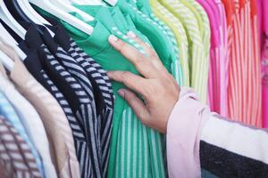 woman choosing clothes in shop. photo