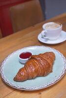 fresh baked croissant on plate with copy space photo