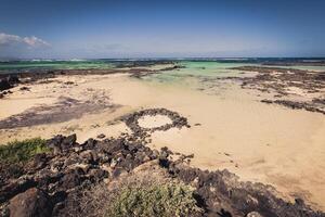 The coast of Atlantic ocean near town Orzola on Lanzarote, Canary islands, Spain photo