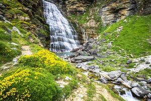 Cascada Cola de Caballo waterfall under Monte Perdido at Ordesa Valley Aragon Huesca Pyrenees of Spain photo