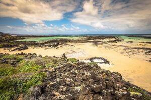 The coast of Atlantic ocean near town Orzola on Lanzarote, Canary islands, Spain photo