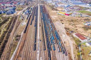 Cargo trains. Aerial view of colorful freight trains on the railway station. Wagons with goods on railroad.Aerial view photo