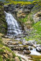 Cascada Cola de Caballo waterfall under Monte Perdido at Ordesa Valley Aragon Huesca Pyrenees of Spain photo