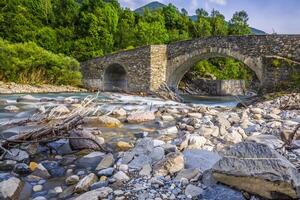 View of old stone bridge over river photo