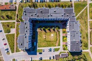 Aerial city view with crossroads and roads, houses, buildings, parks and parking lots. photo