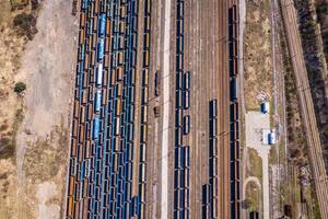 Cargo trains. Aerial view of colorful freight trains on the railway station. Wagons with goods on railroad.Aerial view photo