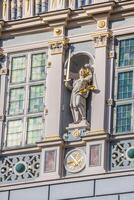 Statue of justice with scales and a sword in the historic center of Gdansk. photo