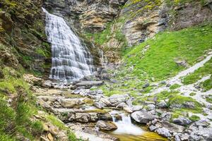 Cascada Cola de Caballo waterfall under Monte Perdido at Ordesa Valley Aragon Huesca Pyrenees of Spain photo