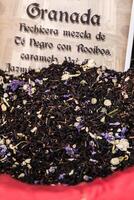 Spices, seeds and tea sold in a traditional market in Granada, Spain photo