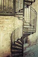 Very old outdoor spiral staircase photo