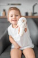 Little girl with broken finger at the doctor's appointment in the hospital photo