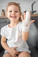 Little girl with broken finger at the doctor's appointment in the hospital photo