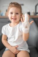 Little girl with broken finger at the doctor's appointment in the hospital photo