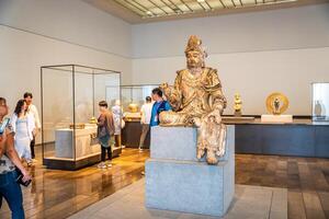 Abu Dhabi, UAE - December 6, 2023 Interior of Louvre and Visitors looking at exhibits, museum in Abu Dhabi, UAE photo