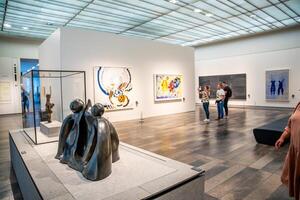 Abu Dhabi, UAE - December 6, 2023 Interior of Louvre and Visitors looking at exhibits, museum in Abu Dhabi, UAE photo