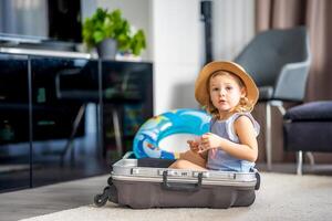 Little girl in suitcase baggage luggage ready to go for traveling on vacation photo