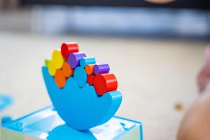 Wooden balancing toy on the floor in home living room. Focus on balancer photo