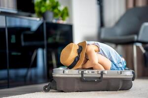 Little girl in suitcase baggage luggage ready to go for traveling on vacation photo