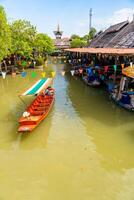 Pattaya, Thailand - December 29, 2023. Floating open air market with small houses - shops on the pond in Pattaya, Thailand. High quality photo