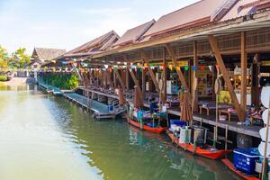 Pattaya, Thailand - December 29, 2023. Floating open air market with small houses - shops on the pond in Pattaya, Thailand photo