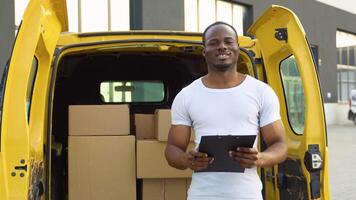 African american courier with clipboard near delivery van outdoors video