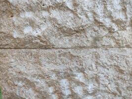 brown cream stone wall texture which is usually installed on the walls of houses or luxury villas photo