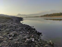 calm sea water suitable for harbor with views of seafront hills photo