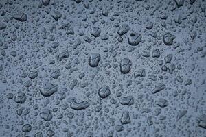 raindrops on the metallic surface in rainy days photo