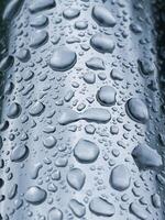 raindrops on the metallic surface in rainy days photo