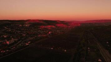 Aerial view of amazing bright red sunset over the town. Shot. Beautiful landscape video