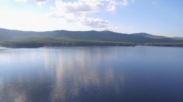 Aerial view of a small lake in the middle of a forest. Beautiful landscape sea, forest and rocks video