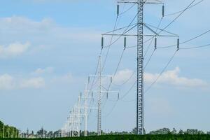 Transmission tower on a background field of soybeans photo