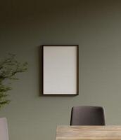 simple and aesthetic dark wooden frame mockup poster hanging on the green wall in the dining room photo