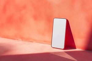 AI generated Smartphone mockup with white screen display, leaning against an orange wall, used for template design photo
