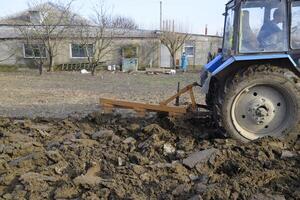 Tractor plowing the garden. Plowing the soil in the garden photo