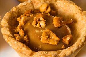 a close up of a pastry with nuts and caramel photo