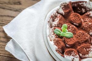 Portion of roasted marshmallows with cocoa powder photo