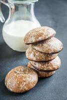 Gingerbread cakes with jug of milk photo