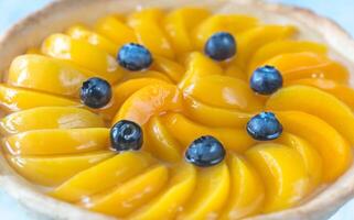 Tart with peaches and blueberry photo