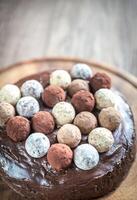 Sacher torte decorated with truffles photo